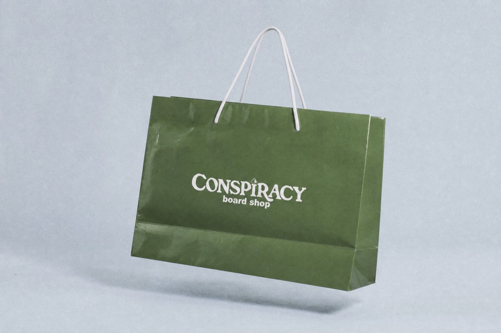 The Conspiracy Board Shop mark printed on a retail shopping bag
